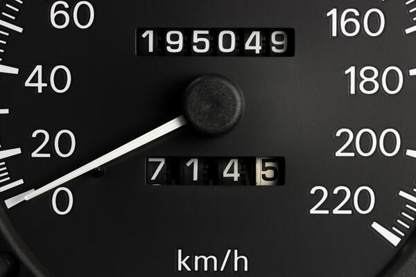 Close-up of a car odometer showing 195,049 miles illustrating what a high mileage used car looks like and how many miles is too many on a used car