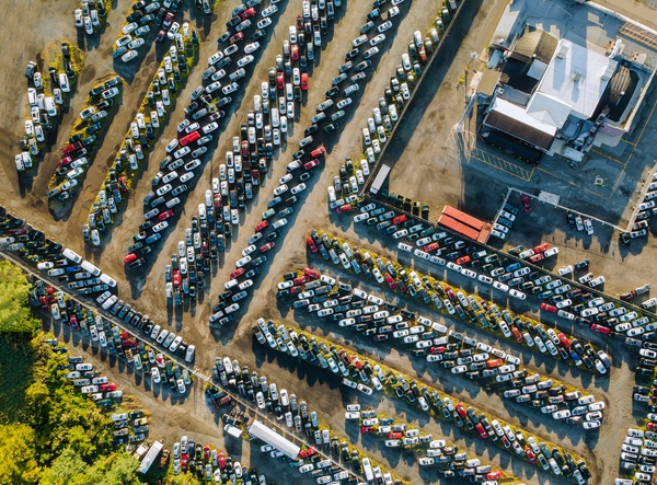 Aerial photo of dealer auctions showing rows of cheap used cars and auctions in a public auction lot where there is potential for savings on used cars.