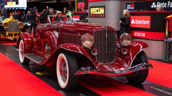 Restored classic red roadster on display at the Mecum Dallas auction