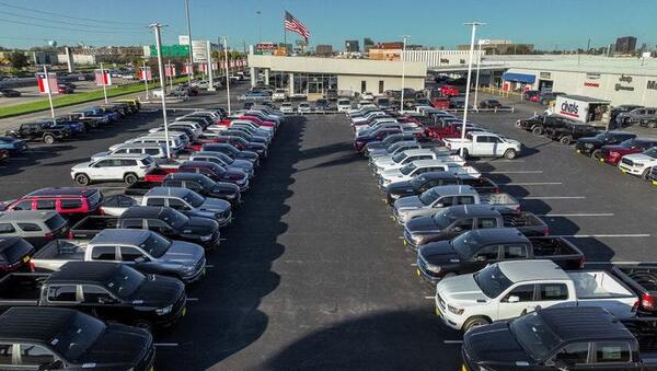 Aerial view of a dealer auto auction in Dallas with rows of used cars and trucks