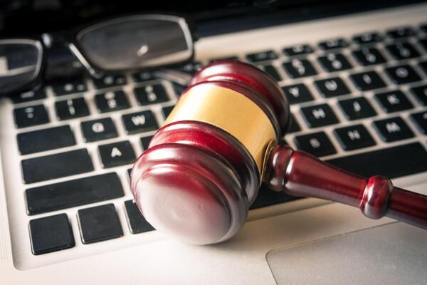 Gavel on laptop representing online car auctions LA and VIN check car auction research